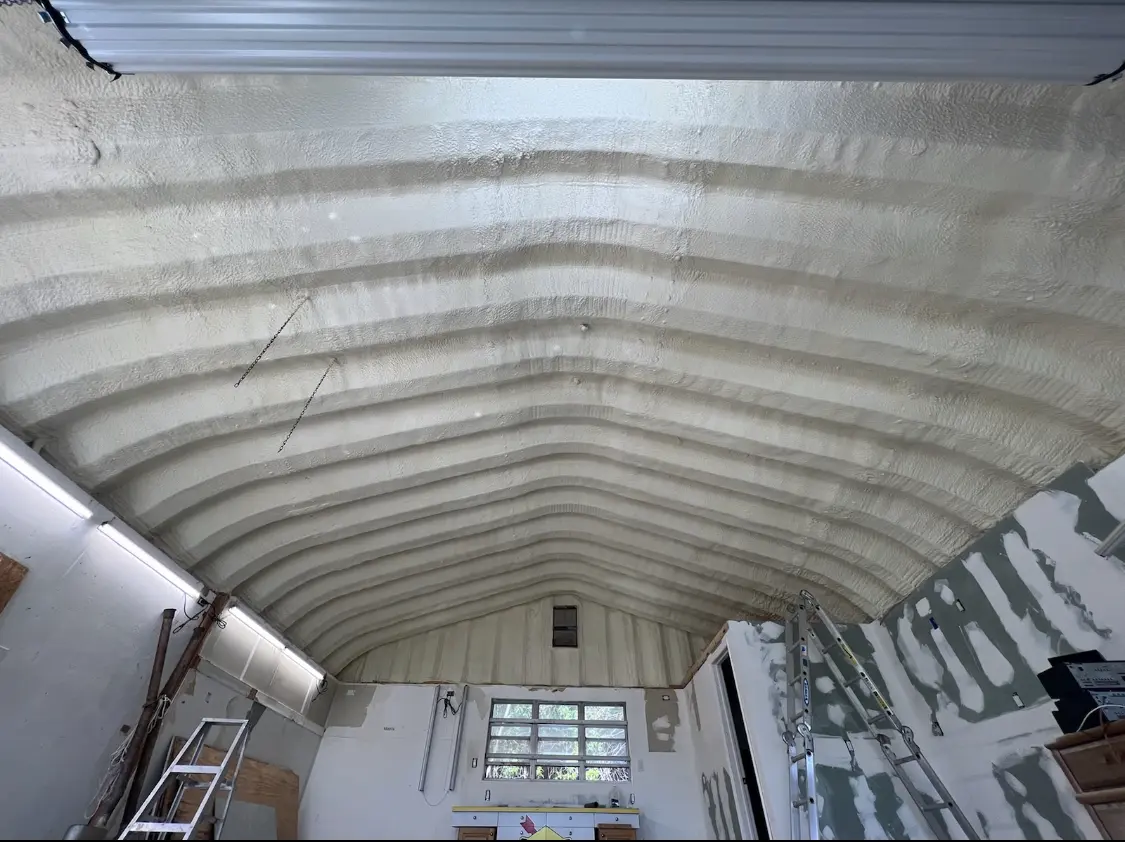 Spray polyurethane foam applied to the underside of a metal roof deck in Rochester